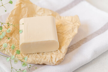 Wooden soap dish, craft paper, cotton fabric, soap, over white background. Zero waste, natural organic bathroom tools. Plastic free life. Ecological skin care, body treatment concept