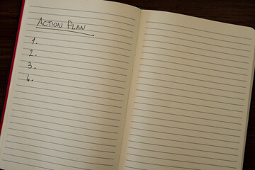 Lined notebook page with the words 'Action plan' in black ink on white paper.