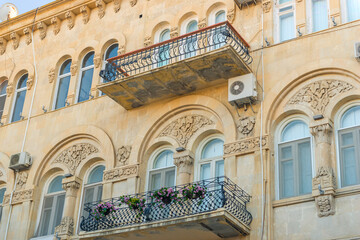 Fototapeta na wymiar Beautiful vintage balcony with colorful flowers and door