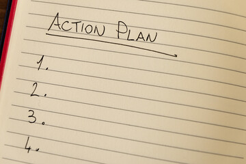 Lined notebook page with the words 'Action plan' in black ink on white paper.