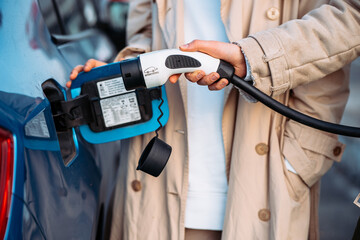Friends refuel car in gas station. Close up view