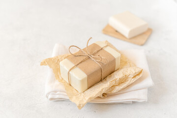 Wooden soap dish, craft paper, cotton fabric, soap, over white background. Zero waste, natural organic bathroom tools. Plastic free life. Ecological skin care, body treatment concept