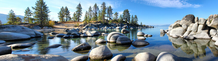Morning sun causes shadows on the boulders at Sand Harbor Lake Tahoe Panorama - obrazy, fototapety, plakaty