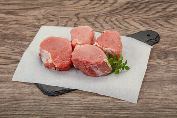 Raw pork medallion served rosemary