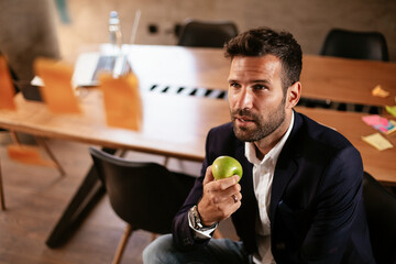 Businessman in conference room use sticky notes on glass wall. Handsome businessman making a business plan.