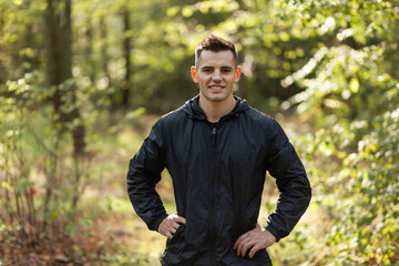 Portrait of active cheerful man in the forest