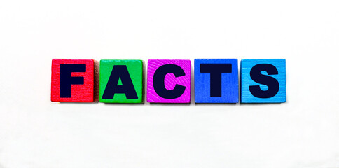 The word FACTS is written on colorful cubes on a light background