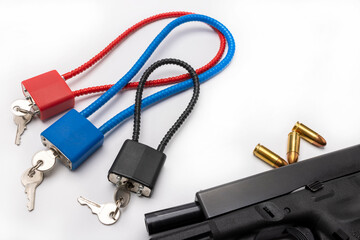 Weapon cable lock keys used to safely secure a firearm from being used , Gun safety and control concept