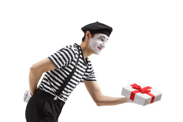 Profile shot of a mime giving a gift box