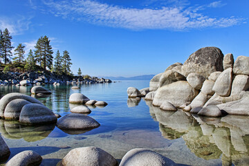 First light of day brightens the boulders at Sand Harbor on Lake Tahoe. - obrazy, fototapety, plakaty