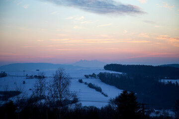 beautiful sunset over mountain range with Tatra Mountains on the horizon
