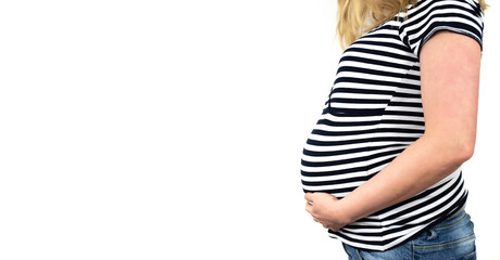 side view of midsection of 9 months pregnant woman in striped top an jeans with hands on belly against white background