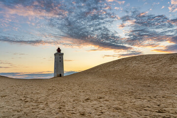 Lighthouse on a large sand dune in front of the Baltic Sea in Jutland, Denmark