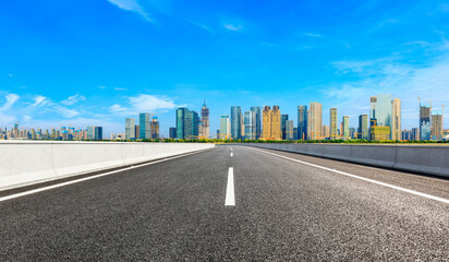 Empty asphalt road and modern city skyline with buildings in Hangzhou.