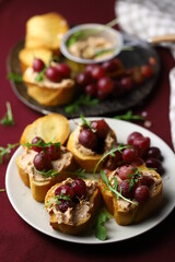 Fototapeta na wymiar Selective focus. Toast with goose liver pate and baked grapes. A gourmet snack. Keto.