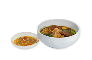 Boil pork knuckle with sour sauce in a white cup.
