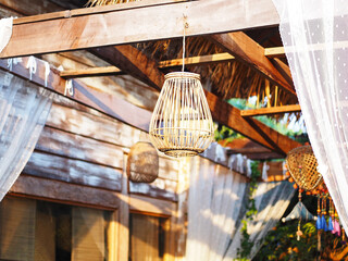 Obraz na płótnie Canvas rattan lantern hanging from wooden ceiling