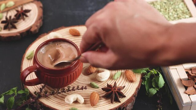 Indian Masala Chai traditional beverage tea with milk spices Kerala India Sri Lanka 4K slow motion video footage. Two cups organic tulsi tea ayurvedic herbal drink, good in winter immunity boosting.