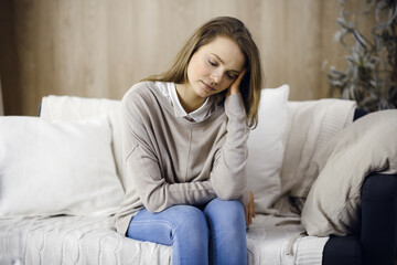 Obraz premium Tired upset woman worried about tiredness from work at home office and self isolation quarantine for COVID-19 Coronavirus. Mental health, anxiety depressed thinking young lady