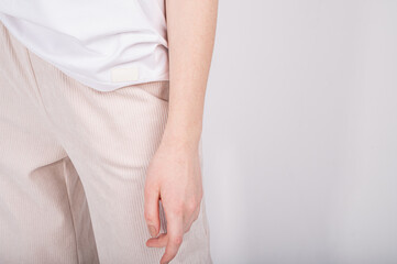 Cropped view of basic women's clothes. Woman minimalist wardrobe in white and beige. Zero waste shopping