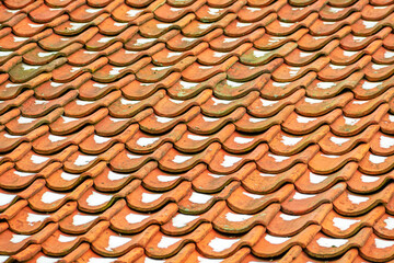 Old shingles on the roof slightly covered with snow