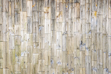 Wall covered with weather-beaten wooden planks.
