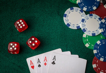 Stack of chips and two aces on the table on the green baize - poker game concept