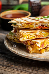 quesadilla Traditional Mexican tortillas with scramble eggs, vegetables, ham and cheese. vertical image