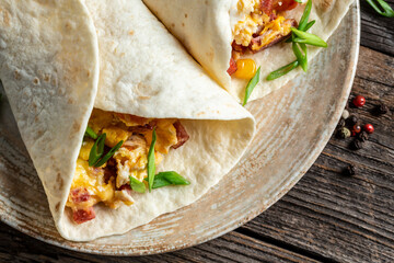 Mexican tortilla quesadilla with scramble eggs, vegetables, ham and cheese, Mexican cuisine. Food recipe background. space for text. top view