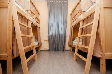 Obraz na płótnie Canvas Hostel has cozy bunk beds. Budget holiday destination for travelers, tourists and students. Copy space