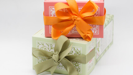 Pink gift box on the green box with bows for a celebration