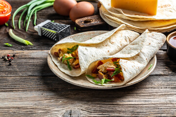 Breakfast quesadilla with fried eggs, bacon, cheese, Mexican food cuisine traditional dish. Food recipe background. space for text. top view