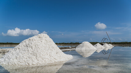 Salt pile on field with blue sky on daylight 