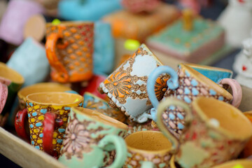 Fototapeta na wymiar Ceramic dishes, tableware and jugs sold on Easter market in Vilnius. Lithuanian capital's traditional crafts fair is held every March on Old Town streets.