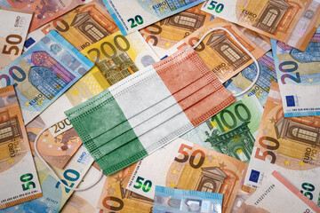 Obraz na płótnie Canvas Medical mask with the flag of Ireland on a variety of european banknotes.(series)