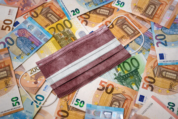 Medical mask with the flag of Latvia on a variety of european banknotes.(series)
