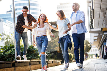 	
Group of young people hangout at the city street.They walks together and making fun.	
