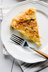 Savory pie with cheese and spinach on the plate