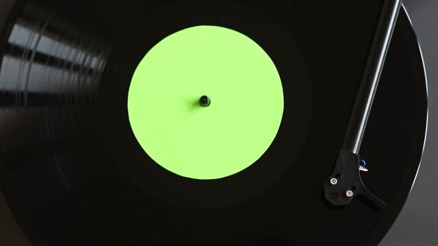 Turntable playing vinyl LP record top view. Party, leisure, music, hobby, enjoying life, having fun, technology concept