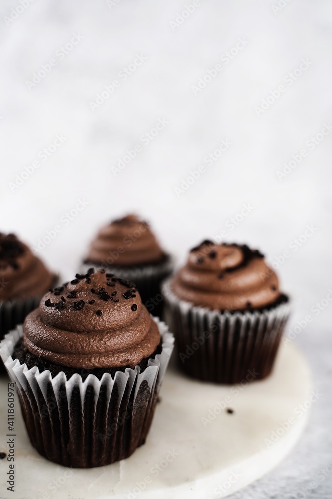 Sticker chocolate cupcake served in on a plate, selective focus