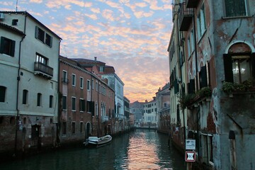 Colorful cloudy sunset on a canal of Venice