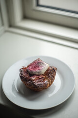 Black currant danish traditional carnival bun fastelavnsboller, danish pastry with laminated dough, black currant jam, whipped cream and powdered sugar, yummy dessert