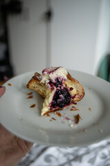 Black currant danish traditional carnival bun fastelavnsboller, danish pastry with laminated dough, black currant jam, whipped cream and powdered sugar, yummy dessert