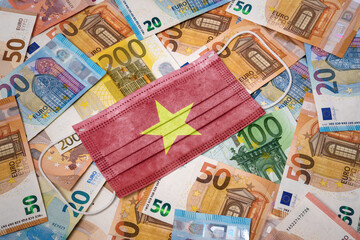 Medical mask with the flag of Vietnam on a variety of european banknotes.(series)