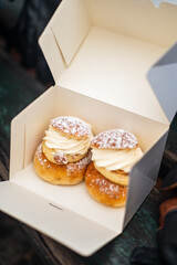 Traditional fastelavnsboller semla semlor swedish february dessert, traditional scandinavian sweet bread with almond cream paste and whipped cream. Cardamom bun and powdered sugar delicious treat