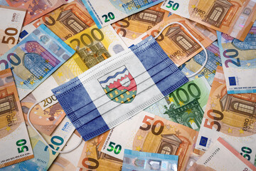 Medical mask with the flag of Northwest Territories on a variety of european banknotes.(series)