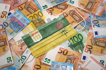 Medical mask with the flag of Saskatchewan on a variety of european banknotes.(series)