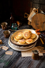 tasty fried cottage cheese pancakes (syrniki) on ceramic plate with powdered sugar on top. morning food. selective focus