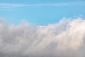 Naklejka na ściany i meble Thick clouds over the mountains