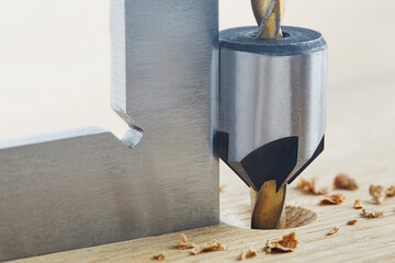 Countersink drill bit with steel triangle ruler make sink in hole for screw in wooden oak plank